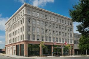 a large white building on the corner of a street at AC Hotel by Marriott Little Rock Downtown in Little Rock