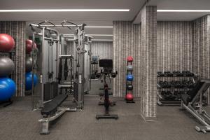a gym with weights and equipment in a room at AC Hotel by Marriott Little Rock Downtown in Little Rock