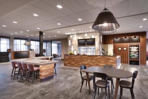 a lobby with two tables and chairs and a bar at Courtyard by Marriott Cedar City in Cedar City