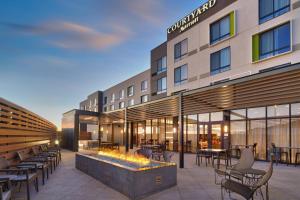 a rendering of a hotel patio with tables and chairs at Courtyard by Marriott Cedar City in Cedar City