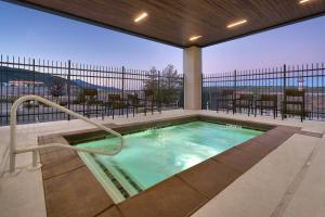 a hot tub on a balcony with tables and chairs at Courtyard by Marriott Cedar City in Cedar City