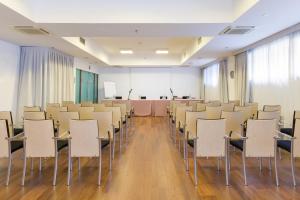 a room with rows of chairs and a podium at Courtyard by Marriott Venice Airport in Tessera