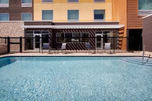 a large swimming pool in front of a building at Fairfield Inn & Suites by Marriott Tampa Wesley Chapel in Wesley Chapel