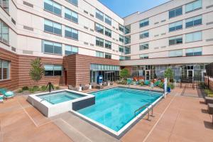 an image of a swimming pool in front of a building at Aloft Denver North Westminster in Westminster