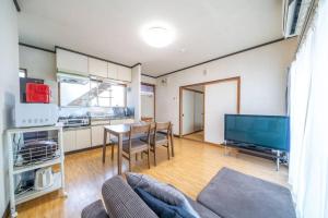 a living room with a couch and a table and a tv at コーポセキヤ / Corp Sekiya in Itoigawa