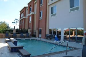 a swimming pool in front of a building at Fairfield Inn & Suites Houston Channelview in Channelview