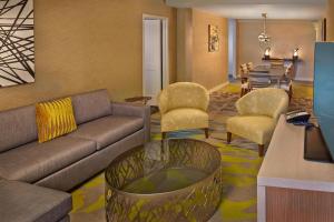 a living room with a couch and chairs and a table at Courtyard by Marriott Philadelphia City Avenue in Philadelphia