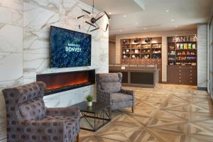 a lobby with two chairs and a fireplace at Four Points by Sheraton Windsor Downtown in Windsor
