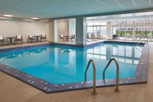 a large swimming pool in a hotel room at Four Points by Sheraton Windsor Downtown in Windsor