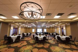 a banquet hall with tables and chairs and a chandelier at Courtyard Page at Lake Powell in Page