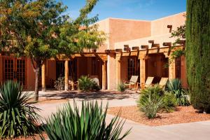a building with chairs and trees in a courtyard at Courtyard Page at Lake Powell in Page
