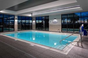 een groot zwembad in een gebouw met ramen bij Courtyard Pasco Tri-Cities Airport in Pasco