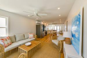 a living room with a couch and a table at Brigantine Waterfront Vacation Rental with Grill in Brigantine