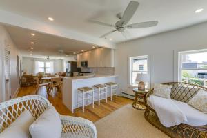 a living room with two couches and a kitchen at Brigantine Waterfront Vacation Rental with Grill in Brigantine