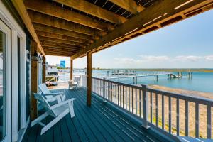 a porch with two chairs sitting on a house at Brigantine Waterfront Vacation Rental with Grill in Brigantine