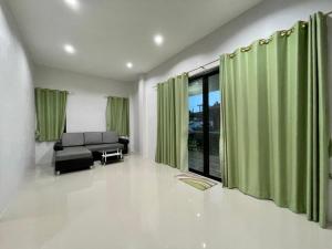 a living room with green curtains and a couch at Shine of Hill Lamai Koh Samui in Lamai