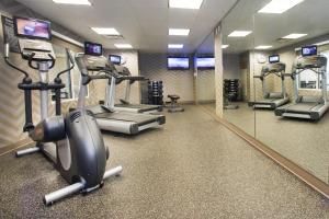 a gym with treadmills and elliptical machines and mirrors at Residence Inn Paducah in Paducah