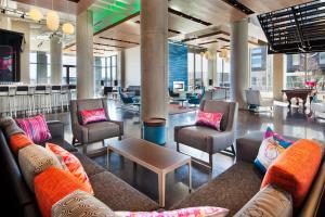 a lobby with couches and chairs and a table at Aloft Boston Seaport District in Boston