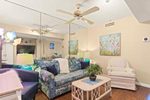 a living room with a couch and a chair at Cozy & Charming Oceanfront Condo #803 @ Buena Vista in Myrtle Beach