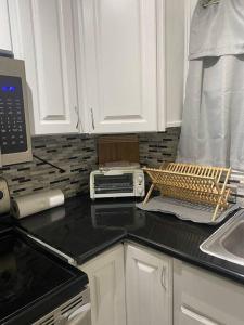a kitchen with a counter top with a toaster and a microwave at Condo in the middle of Everything! in Nassau