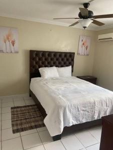 a bedroom with a bed and a ceiling fan at Condo in the middle of Everything! in Nassau