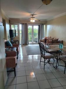 a living room with a couch and a table and chairs at Condo in the middle of Everything! in Nassau