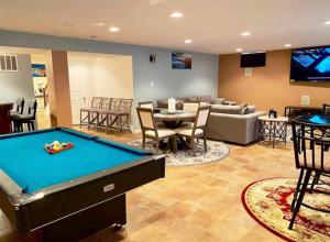 a living room with a pool table and a couch at Van Gogh Guest Rm #7 • Van Gogh 7-Private BSMT Rm in single family home in Rosedale