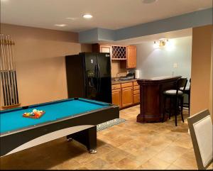 a kitchen with a pool table and a refrigerator at Van Gogh Guest Rm #7 • Van Gogh 7-Private BSMT Rm in single family home in Rosedale