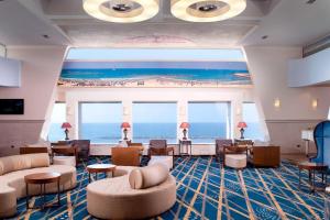 a hotel lobby with a view of the ocean at Renaissance Tel Aviv Hotel in Tel Aviv