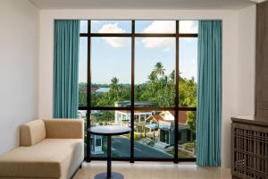 a living room with a couch and a large window at Fairfield by Marriott Belitung in Tanjungpandan