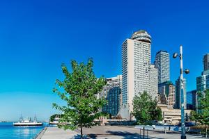 a view of a city skyline with a tree and water at The Westin Harbour Castle, Toronto in Toronto