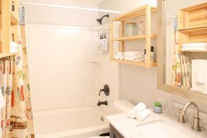 a bathroom with a tub and a sink and a shower at License to Chill - Heated Pool, Indian Rocks Beach, Play Room in Largo