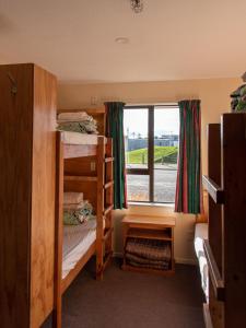a room with two bunk beds and a window at Snow Denn Lodge in Methven