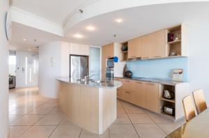a large kitchen with a large island in the middle at Resort Apartment with Ocean Views in Maroochydore