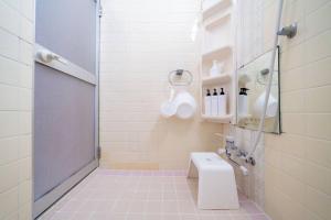 a white bathroom with a shower and a toilet at えのきや in Itoigawa