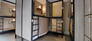 a row of glass doors in a room at Hostel Leblon in Rio de Janeiro