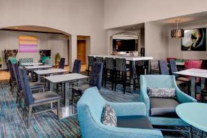a restaurant with tables and chairs and a bar at Residence Inn by Marriott Cleveland Mentor in Mentor