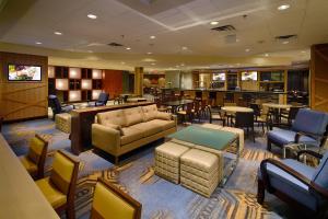 a waiting room with couches and chairs and tables at Delta Hotels by Marriott Winnipeg in Winnipeg