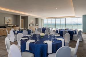 a conference room with blue tables and white chairs at Residence Inn by Marriott Panama City in Panama City