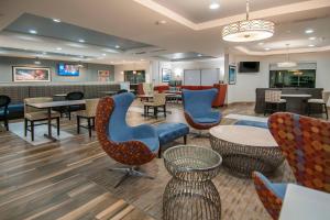 a lobby with chairs and tables and a waiting room at TownePlace Suites by Marriott Vidalia Riverfront in Vidalia