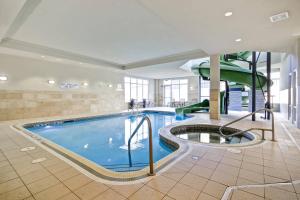 a swimming pool with a slide in a building at Fairfield Inn & Suites by Marriott Guelph in Guelph