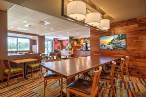 ein Esszimmer mit einem großen Holztisch und Stühlen in der Unterkunft Fairfield Inn & Suites by Marriott Greenville in Greenville