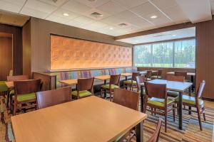 a restaurant with tables and chairs and a large window at Fairfield Inn & Suites by Marriott Greenville in Greenville