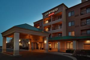 a hotel building with a sign that reads comfort inn at Courtyard Chicago St. Charles in Saint Charles