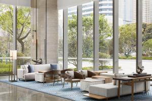 a lobby with white furniture and large windows at Sheraton Fuqing Hotel in Fuqing