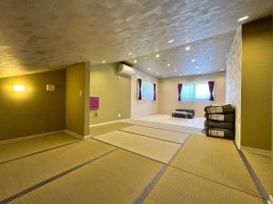 a large room with a living room with a couch at SHIRAHAMA condominium D-100 in Kanayama