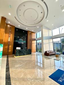 a lobby of a building with a large ceiling at The Emerald Golf View in Thuan An