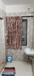 a bathroom with a sink and a shower curtain at SAMPATH RESIDENCY in Palani