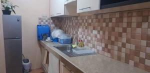 a kitchen counter with a sink and a refrigerator at Lemon Transient House in Angeles