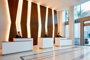 three men sitting at tables in a lobby at Residence Inn by Marriott at Anaheim Resort/Convention Center in Anaheim